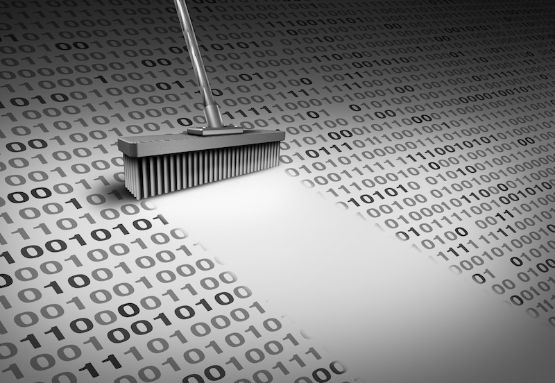 Photograph of binary code being swept away by a brush to illustrate article by Paul Mullins of AlgoMe Consulting about data efficiencies in asset management firms